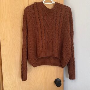 Double Zero Cable Knit Sweater in a burnt red.